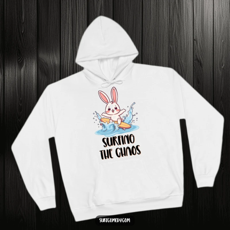 Funny rabbit surfer character comically wiping out in a water splash on a cozy hoodie, radiating surprise and seaside fun.