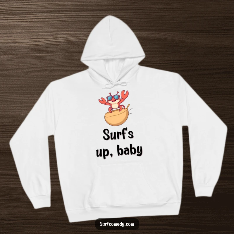 Funny hoodie featuring a playful crab wearing sunglasses, riding a coconut like a surfboard, bringing laid-back humor and warmth.