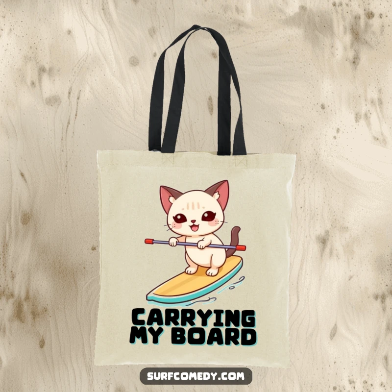 Funny Siamese cat happily balancing unsteadily on a paddleboard on a tote bag, perfect for beach trips and carrying essentials.